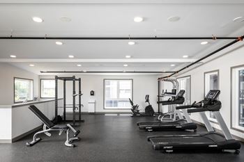 a gym with treadmills and other exercise equipment